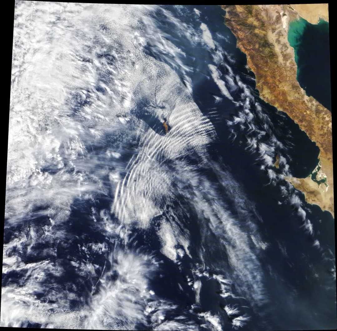When the Moderate Resolution Imaging Spectroradiometer (MODIS) on NASA’s Terra satellite captured this natural-color image on October 4, 2020, a series of undulating cloud bands—an undular bore—ripple